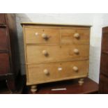 19th Century stripped pine chest of two short over two long drawers with knob handles, raised on