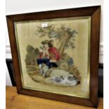 19th Century woolwork picture of seated man with dog under a tree, signed M. Smith, dated 1858 in an
