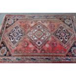 Small South West Persian rug with a triple medallion design on a rose ground with borders, 5ft