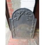 Small cast iron fire back relief decorated with cherubs and swags, 27.25ins x 19.75ins