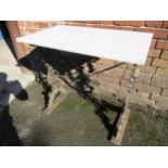Black painted cast iron garden table, with white flecked marble top