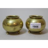 Pair of miniature Chinese bronze cauldron form jardinieres on ball supports, indistinct mark to base