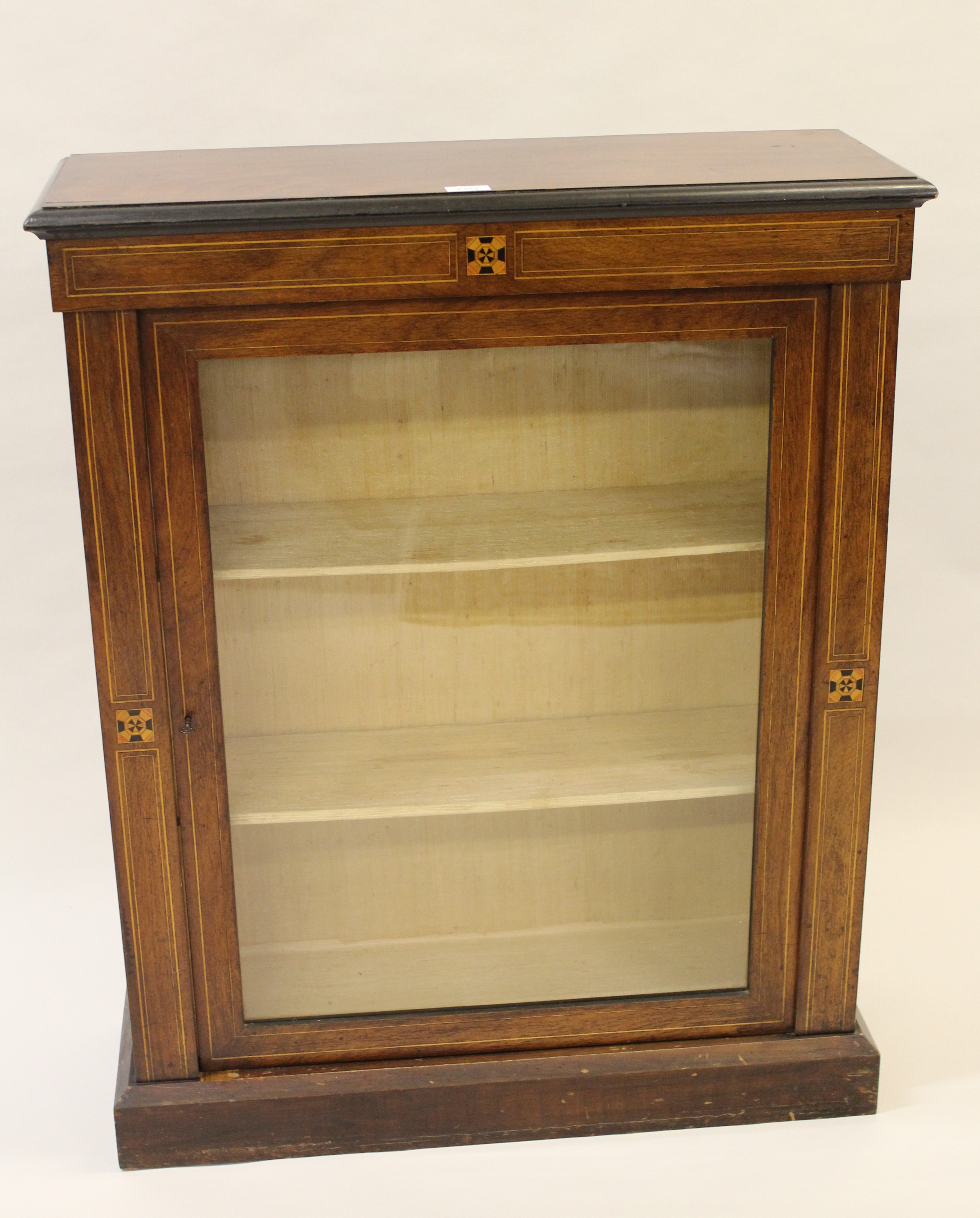 Victorian walnut and inlaid pier cabinet with a single glazed panel door enclosing shelves, 32ins