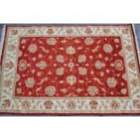 Modern Afghan Ziegler design rug with an all-over palmette pattern on a red ground with beige ground