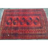 Small Afghan rug with a single row of four gols on a red ground with borders, 6ft x 3ft 10ins
