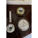 Art Deco oak aneroid barometer, inscribed S&M, stormoguide, together with another circular carved