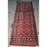 Pakistan Turkoman design runner having two rows of gols with multiple borders on a red ground, 230 x