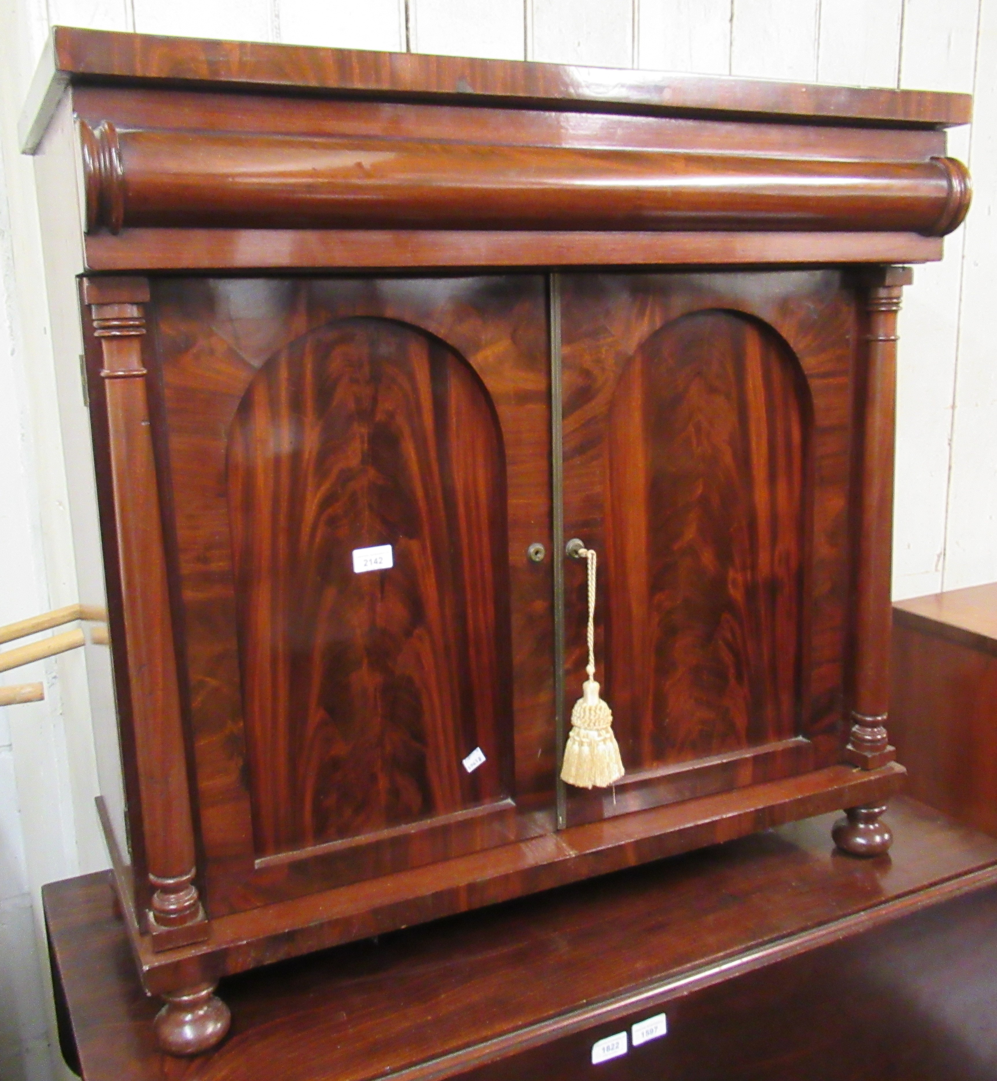 William IV mahogany side cabinet having single moulded drawer above two arch top panelled doors on