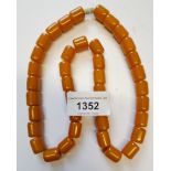 Reconstituted amber necklace of cylindrical form