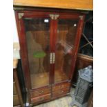 Modern oriental stained wood and brass mounted two door bookcase, 60ins x 34ins, and another smaller