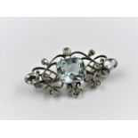 Unmarked white metal aquamarine and rose cut diamond brooch, the centre stone approximately 12mm x