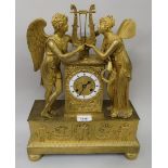 Early 19th Century French ormolu mantel clock, the circular enamel dial flanked by two figures of