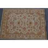 Afghan Ziegler carpet with an all-over stylised floral design on a beige ground with borders, 8ft