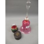 Cranberry and clear glass table bell, 11ins high, together with a medicine glass in a leather case