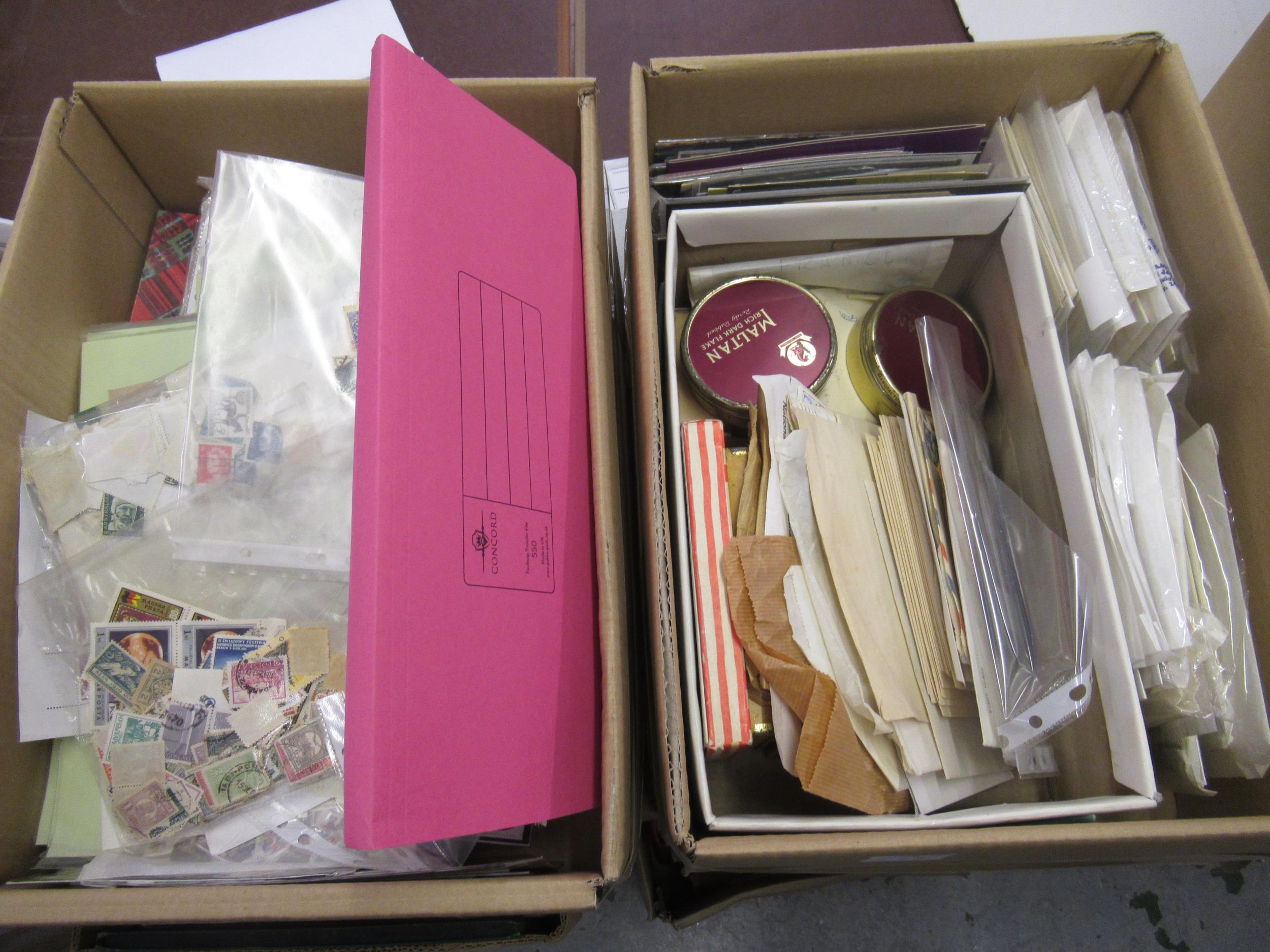 Two boxes containing a collection of World and Commonwealth stamps in packets and on album pages etc