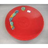 Poole pottery, large circular wall charger in Volcano pattern on a dark red ground, 16ins diameter