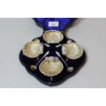 Cased set of four Victorian silver shell form salts with apostle handled spoons 5.5ozs