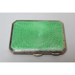 Birmingham silver and green translucent enamel cigarette case of irregular octagonal form, 8cm wide