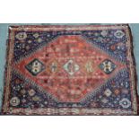 Modern Qashqai carpet with a five medallion and all-over stylised floral design on a red ground,
