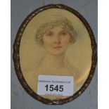 Oval metal framed miniature head and shoulder portrait of a lady and another gilt metal oval