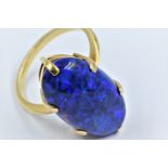 High carat yellow metal and black opal claw set ring, circa 1970's, the oval stone approximately