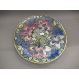 Doulton Lambeth stoneware charger, decorated with stylised floral design in blue, pink and green, by