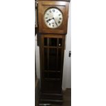 Early to mid 20th Century oak longcase clock, the circular silvered dial with Roman numerals and