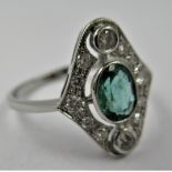 Platinum ring set single oval emerald surrounded by diamonds in a pierced setting, size N