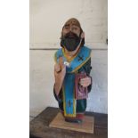 Painted carved wooden figure of a clergyman, 40ins high
