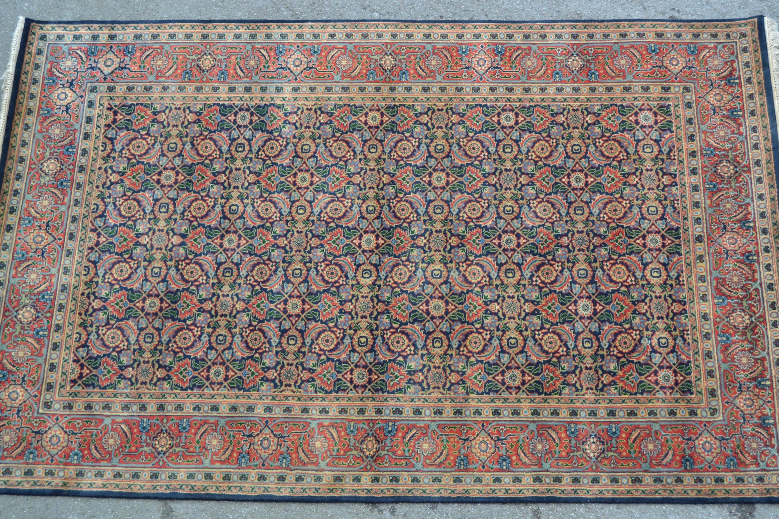 Indo Persian rug with an all-over Herati design on a midnight blue ground with brick red borders,