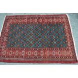 Small 20th Century Turkoman rug with an all-over stylised flower head design on a blue / green
