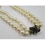 Double row uniform cultured pearl necklace with 14ct white gold and sapphire set clasp, the pearls