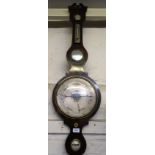 19th Century rosewood wheel barometer, with silvered dials Good overall condition Length = 42.5ins