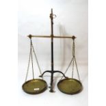 Pair of iron and brass balance scales with black and gilt painted finish (lacking weights)