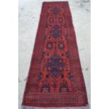 Modern Afghan Belouch runner with a triple medallion and all-over design on a rust ground with