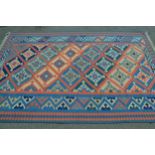 Kelim rug with an all-over stylised flower head design in shades of blue, cream and pink with