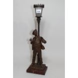 Early 20th Century French spelter patinated figure of a young boy with cap, beneath a lamppost on