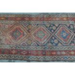 Kurdish rug with a triple medallion design in shades of rose, beige and dark blue, 6ft 6ins x 3ft