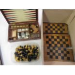 Box containing a collection of chessboards and chess pieces, including a games compendium (at fault)