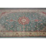 Indo Persian rug with lobed medallion and all-over stylised floral design on a blue / green ground