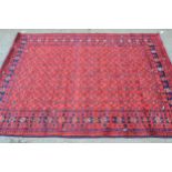 Indo Persian rug of Belouch design with an all-over stylised flower head pattern on a red ground