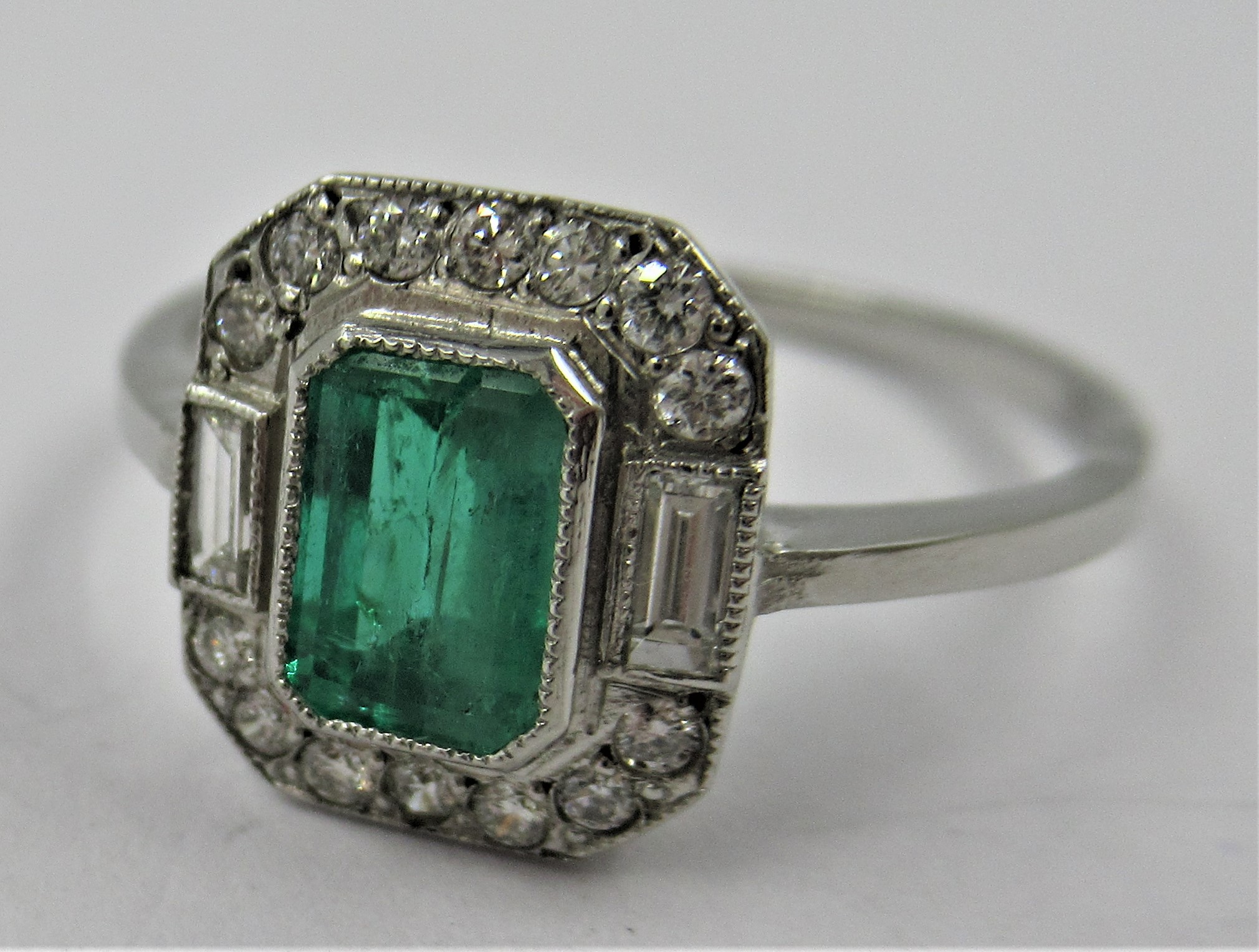 Platinum ring set with central octagonal emerald surrounded by diamonds, size N 2.9g Dimensions of