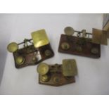 Three various brass and wooden sets of postal scales