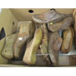 Box containing a quantity of antique wooden shoe trees