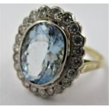 18ct Yellow gold ring set large oval aquamarine surrounded by diamonds