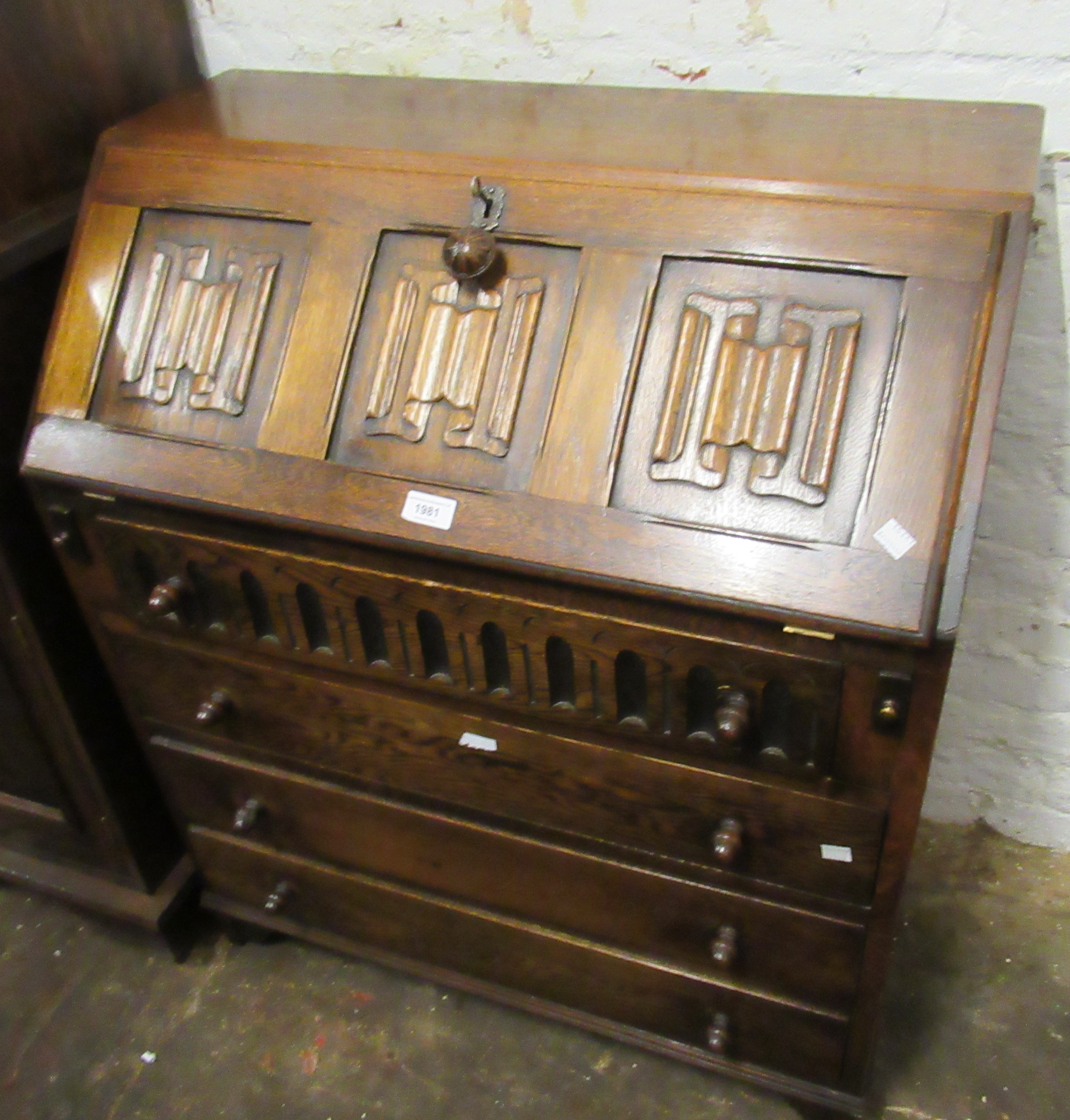 Reproduction oak bureau with three panel fall front above four drawers, together with a similar