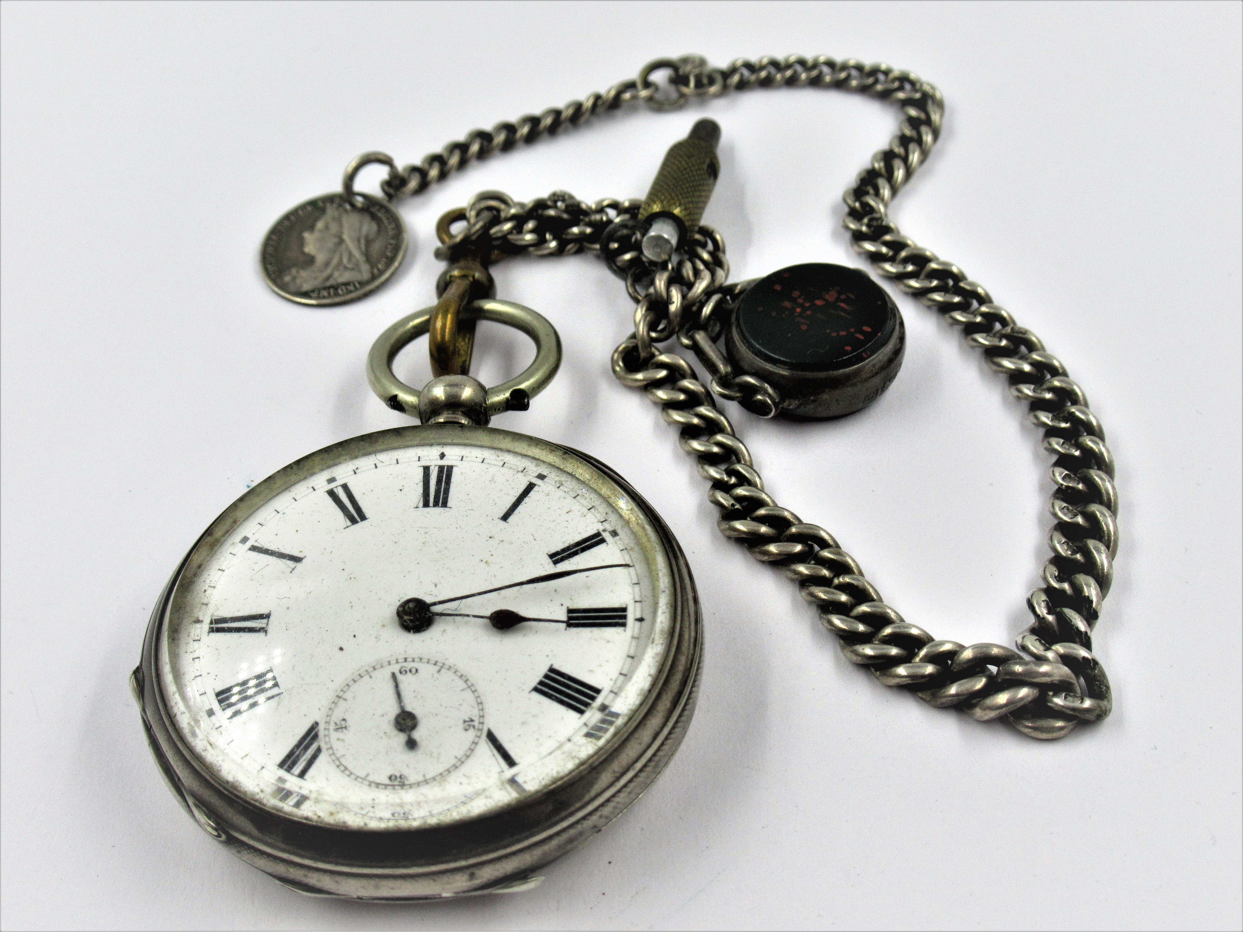 Continental sterling silver cased keywind open face pocket watch, suspended from a silver Albert
