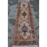 Modern machine woven rug of Persian design with a triple medallion on a rose ground with borders,