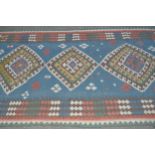 Kelim rug with a triple medallion design on pale blue ground with borders, 7ft x 4ft 6ins