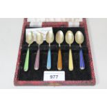 Cased set of six Continental silver gilt and enamel decorated coffee spoons